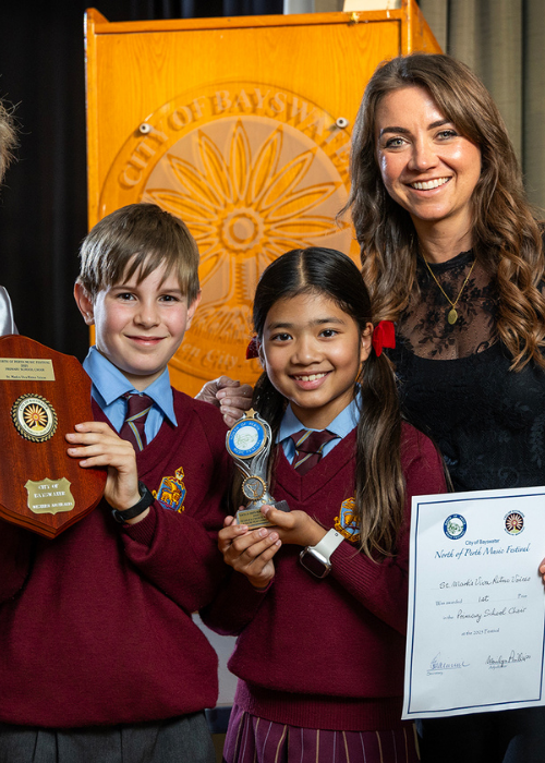 Two young winners hold their trophy and certificate.
