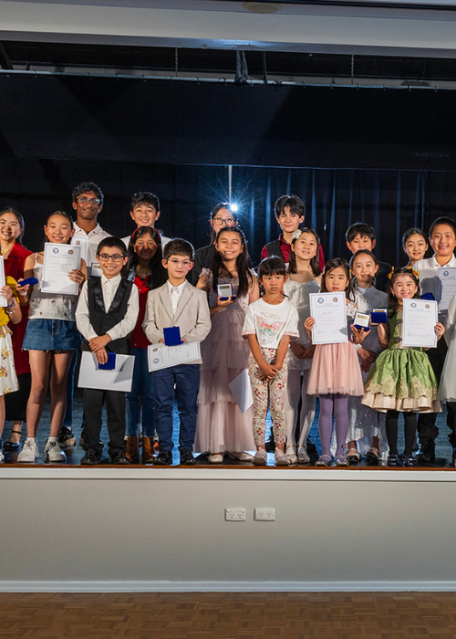 A large group of Festival winners pose with their trophies and certificates.